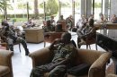 Members of the UN observers mission in Syria wait at a hotel lobby in Damascus