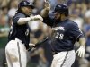 Milwaukee Brewers' Rickie Weeks congratulates Prince Fielder (28) after Fielder hit a home run during the sixth inning of a baseball game against the Colorado Rockies Tuesday, Sept. 13, 2011, in Milwaukee. (AP Photo/Morry Gash)