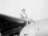 FILE - In this undated photo, Amelia Earhart, the first woman to cross the Atlantic Ocean by plane sits on top of a plane. Secretary of State Hillary Rodham Clinton is wading into one of the 20th century’s most enduring mysteries: the fate of American aviator Amelia Earhart, disappeared over the South Pacific 75 years ago. Clinton is meeting March 20, 2012, with historians and scientists from The International Group for Historic Aircraft Recovery, which will launch a new search in June for the wreckage of Earhart’s plane off the remote island of Nikumaroro. (AP Photo)