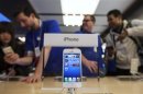 An Apple iPhone 5 phone is displayed in the Apple Store on 5th Avenue in New York