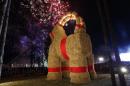 A traditional Christmas goat is unveiled in Gavle, Sweden, Sunday, Nov. 27, 2016. Sweden's Christmas Goat - a giant decorative goat made of straw and wood - is celebrating its 50th birthday, but revelers are being asked to keep the candles away. Every Christmas season since 1966, the city of Gavle in central Sweden builds a giant version of the straw goat, an ancient Scandinavian Yuletide character that precedes Santa Claus as a bringer of gifts, but it also attracts arsonists and seldom survives the season without someone trying to burn it down. To improve its odds this year, the goat set up on Sunday was equipped with closed-circuit TV. (Pernilla Wahlman/TT News Agency via AP)
