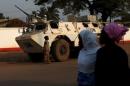 Women walk by a U.N. peacekeeping armoured vehicle in the mostly muslim PK5 neighbourhood of Bangui