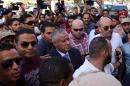 Libyan Prime Minister Ali Zeidan (C) arrives at the government headquarters in Tripoli on October 10, 2013