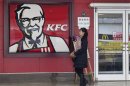 File photo shows a woman walking past a KFC restaurant in Wuhan, Hubei province