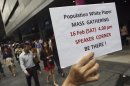 Supporter of public protest informs public of event during lunch hour in Singapore