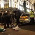 Police examine blood stained clothes at the scene of a second stabbing close to the junction of Oxford Street and Regent Street in central London, Monday Dec. 26, 2011. The victim of the second attack was a male who had been stabbed in the legs. His injuries were not life threatening, police confirmed.  The male is receiving treatment in hospital and it is "too early to say" whether the attack was linked to an earlier stabbing, a Scotland Yard spokesman said. In the earlier incident, a teenager was fatally stabbed after an argument broke out in a sports store on London's most famous retail street as thousands of shoppers flocked to Britain's capital seeking post-Christmas bargains.  (AP Photo / Yui Mok/PA)  UNITED KINGDOM OUT