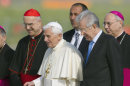 Pope Benedict XVI, flanked by Vatican secretary of state Cardinal Tarcisio Bertone, left, and Italian Premier Mario Monti , arrives at Rome Fiumicino international airport to board a plane on his way to a six-day visit to Mexico and Cuba, Friday, March 23, 2012. (AP Photo/Andrew Medichini)
