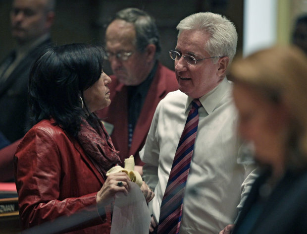 Colorado Senate President John Morse, right, speaks with fellow senator Angela Giron, left, at the State Capitol, in Denver, Friday March 8, 2013. Colorado Senate Democrats advanced an expansion of background checks on firearm purchases as part of a package of bills responding to the shootings in Aurora and Connecticut. The proposal would require background checks where they currently don’t exist, such as purchases online and private sales and transfers. The bill got initial approval in the Senate on an unrecorded vote on Friday. (AP Photo/Brennan Linsley)