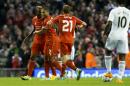 Liverpool's Mario Balotelli, left, celebrates with teammates after scoring against Swansea during the English League Cup soccer match between Liverpool and Swansea at Anfield Stadium, Liverpool, England, Tuesday Oct. 28, 2014. (AP Photo/Jon Super)