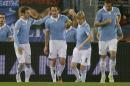 Lazio's Stefano Mauri, center, celebrates with his teammates after he scored during a Serie A soccer match between Lazio and Atalanta at Rome's Olympic Stadium, Saturday, Dec. 13, 2014. (AP Photo/Andrew Medichini)