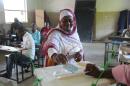 Voters cast their ballot in Mitsoudje on April 10, 2016 during the second round of presidential elections in Comoros