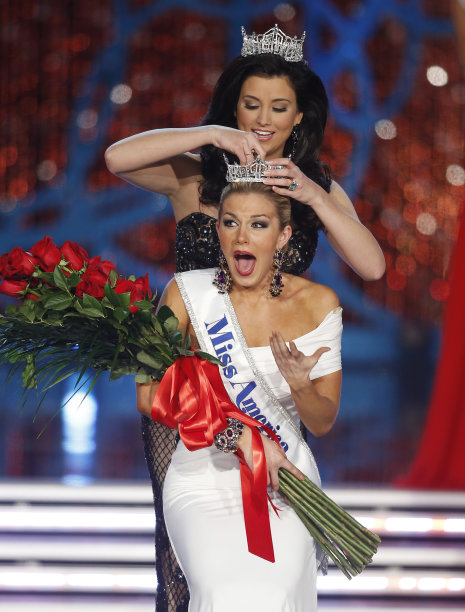 Miss New York Mallory Hagan is crowned Miss America 2013 by Miss America 2012 Laura Kaeppeler on Saturday, Jan. 12, 2013, in Las Vegas. (AP Photo/Isaac Brekken)