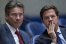 Caretaker Prime Minister Mark Rutte, right, and deputy prime minister Maxime Verhagen, left, are seen in parliament in The Hague, Netherlands, Tuesday April 24, 2012.Rutte appealed to a polarized Dutch Parliament on Tuesday to help him get the economy back on track rather than let the country drift in political limbo until new elections. (AP Photo/Peter Dejong)