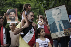 Venezuelans of Arab descent hold up photographs of …