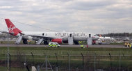 Virgin Atlantic Airbus A330 bound for Orlando sits on the runway at Gatwick Airport, England after it made an a full emergency landing. Virgin Atlantic said four people suffered minor injuries after a plane bound from Britain to Florida made an emergency landing at London's Gatwick Airport on Monday. The airline said that all passengers and crew have safely disembarked the plane, but declined to provide further details on the nature of the injuries, who was affected or what caused the emergency landing.(AP Photo/Lorna Willson/PA) UNITED KINGDOM OUT
