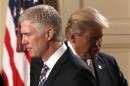 U.S. President Donald Trump steps back as Neil Gorsuch (L) approaches the podium after being nominated to be an associate justice of the U.S. Supreme Court at the White House in Washington