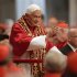 Pope Benedict XVI waves as he arrives to attend a consistory mass in St Peter's Basilica at the Vatican