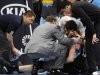 Trainers look at Minnesota Timberwolves power forward Kevin Love after he was hurt in a collision in the first quarter of an NBA basketball game against the Denver Nuggets in Denver, Wednesday, April 11, 2012. (AP Photo/Chris Schneider)