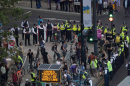 Police surround part of a group of protesting cyclists who tried to block traffic with a mass cycle ride on a road outside the Olympic Park during the Opening Ceremony of the 2012 Summer Olympics, Friday, July 27, 2012, in London. (AP Photo/Ben Curtis)