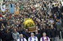 People and relatives follow the casket of Franco Lamolinara prior to his funeral in the northern Italian town of Gattinara, Monday, March 12, 2012. Lamolinara, an engineer who was working in Nigeria when he was kidnapped along with a British colleague in May, was slain during a botched British-Nigerian rescue attempt. (AP Photo/Massimo Pinca)