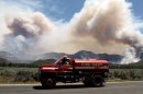 A water tender makes his way back to the the Mountain Fire near Lake Hemet on Tuesday July 16, 2013. The 14,200 acre forest fire near Idyllwild Calif., has caused Idyllwild and adjacent communities east of Highway 243 to issued mandatory evacuations for hundreds of homes Wednesday. (AP Photo/The Press-Enterprise, Frank Bellino)