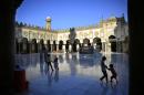 FILE - In this Friday, June 19, 2015 file photo, Egyptian children play as their family awaits the afternoon prayer on the first Friday of the holy month of Ramadan inside the Al-Azhar mosque, in Cairo, Egypt. (AP Photo/Hassan Ammar, File)