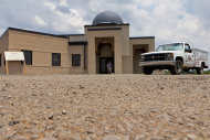 FILE - In a Thursday, June 21, 2012 file photo, a worker walks out of the construction site of a mosque being built in Murfreesboro, Tenn. The Islamic Center of Murfreesboro and its religious leader, Imam Ossama Bahloul, sued Rutherford County on Wednesday, July 18, 2012 and asked the federal court for an emergency order to let worshippers into the building before the holy month of Ramadan starts at sundown on Thursday. In May, a Rutherford County judge overturned the county's approval of the mosque construction and this month he ordered the county not to issue an occupancy permit for the 12,000-square-foot building. (AP Photo/Erik Schelzig, File)