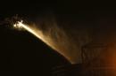 Firemen spray water into one of the cooling towers at Didcot B Power Station in Didcot