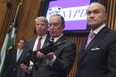 New York City Mayor Bloomberg examines a confiscated gun during a 2012 news conference in New York on major firearms trafficking cases.