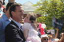 FILE - In this June 6, 2011 file photo, former Pennsylvania Sen. Rick Santorum holds his daughter Isabella before announcing he is entering the Republican presidential race, on the steps of the Somerset County Courthouse in Somerset, Pa. Santorum canceled his morning campaign events, Sunday, Jan. 29, 2012, and planned to spend time with his hospitalized daughter, Bella. Isabella Santorum has Trisomy 18, a genetic condition caused by the presence of all or part of an extra 18th chromosome. (AP Photo/Gene J. Puskar, File)