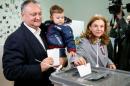 Moldova's Socialist Party presidential candidate Dodon accompanied by his wife Galina and son Nikolai casts his vote at polling station during presidential election in Chisinau