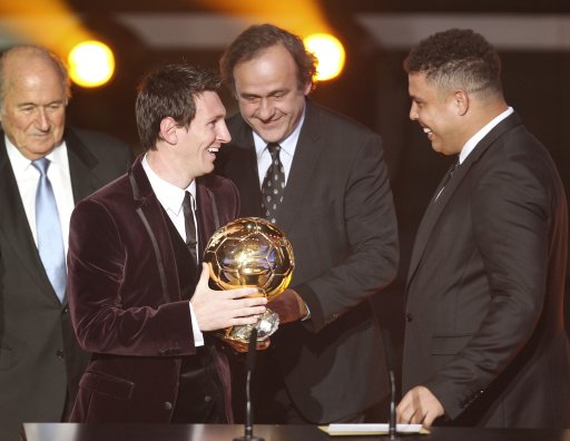 Argentina's Lionel Messi, left, is awarded the prize for the soccer player of the year 2011 by former Brazil player Ronaldo, right, while UEFA President Michel Platini, 2nd right, and FIFA President Joseph Blatter watch them at the FIFA Ballon d'Or awarding ceremony in Zurich, Switzerland, Monday, Jan. 9, 2012. (AP Photo/Michael Probst)