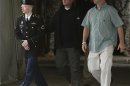 Manning is escorted out after a day of testimony at his court martial trial at Fort Meade