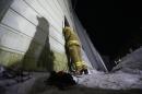 A firefighter looks inside a collapsed resort building from a broken window in Gyeongju