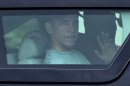 President Barack Obama waves from the window of his motorcade vehicle as he returns from a workout at Marine Corp Base Hawaii, Monday, Dec. 24, 2012, in Kailua, Hawaii. The president and the first family are in Hawaii for a family holiday vacation. (AP Photo/Carolyn Kaster)