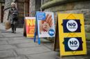 A voter walks past campaign posters outside a polling station in Edinburgh, during Scotland's independence referendum on September 18, 2014