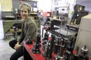In this Feb. 8, 2012 photo, Laurie Schmald Moncrieff president of Schmald Tool and Die in Burton, Mich., sits in her shop. Moncrieff says she began shifting from autos to the green energy, aerospace and defense industries when demand collapsed. (AP Photo/Carlos Osorio)