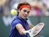 Roger Federer of Switzerland returns a shot against Denis Istomin of Uzbekistan during their match at the BNP Paribas Open ATP tennis tournament in Indian Wells