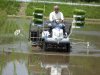 In this May 21, 2012 photo, Toraaki Ogata drives a tractor to plant rice seedlings in a paddy field in Fukushima, northeastern Japan. Last year's crop sits in storage, deemed unsafe to eat, but Ogata is back at his rice paddies, 60 kilometers (35 miles) from the Fukushima Dai-ichi nuclear plant, driving his tractor trailing neat rows of saplings. He's living up to his family's proud, six-generation history of rice farming, and praying that this time his harvest will not have too much radiation to sell. (AP Photo/Yuri Kageyama)