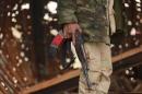 A member of the Libyan pro-government forces holds a weapon during street clashes with the Shura Council of Libyan Revolutionaries in Benghazi