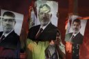 Supporters of deposed Egyptian President Mohamed Mursi carry posters of Mursi during clashes on the Sixth of October Bridge over the Ramsis square area in central Cairo