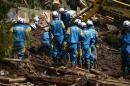 Police search for missing people trapped under houses destroyed by the earthquakes in Minami-Aso, Kumamoto prefecture, southern Japan on April 17, 2016