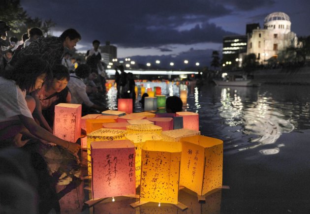 People release paper lanterns on Motoyasu river in remembrance of atomic bomb victims on 67th anniversary of bombing of Hiroshima