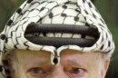 FILE - In this Aug. 13, 2003 file photo, Palestinian leader Yasser Arafat, with tears in his eyes, after he was informed of the death of his sister Yousra Abdel Raouf Al Kidwah at his compound in the West Bank town of Ramallah. French prosecutors opened a murder inquiry into the death of Yasser Arafat on Tuesday, Aug. 28, 2012, judicial officials told a French new agency, after his widow and a TV investigation raised new questions about whether the Palestinian leader was poisoned. (AP Photo/Nasser Nasser, File)