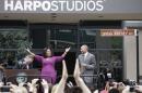 File-This May 11, 2011, file photo shows talk-show host Oprah Winfrey reacting after a street outside her Harpo Studios in Chicago was proclaimed "Oprah Winfrey Way" during a ceremony with Chicago Mayor Richard M. Daley, left, and Bobby Ware, commissioner of the Chicago Department of Transportation. Winfrey is selling Harpo Studios in Chicago to a developer, but the studio will remain on the property for another two years. Harpo Inc. said in a statement that it has entered into a purchasing agreement with Sterling Bay Cos. for the four-building campus on Chicago's West Side. (AP Photo/M. Spencer Green,File)
