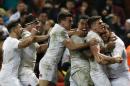 England players celebrate after Elliot Daly (R) scored a second try against Wales at their Six Nations international rugby union match at the Principality Stadium in Cardiff, south Wales, on February 11, 2017