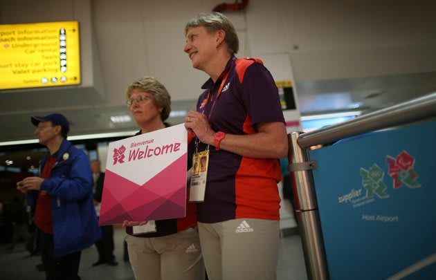 LONDON, ENGLAND - JULY 16: Olympic volunteers wait to greet arriving teams at Heathrow Airport on July 16, 2012 in London, England. Athletes, coaches and Olympic officials are beginning to arrive in L