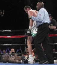 Tyson Fury stands over Steve Cunningham after knocking him out in the seventh round of a heavyweight boxing match on Saturday, April 20, 2013, at the Theatre at Madison Square Garden in New York. (AP Photo/Mary Altaffer)