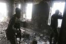 Rebel fighters take positions inside a damaged building during clashes with forces loyal to Syria's President Assad who are stationed in Aleppo's historic citadel