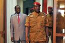 Burkina Faso's interim President Michel Kafando (L) walks with Lieutenant Colonel Isaac Zida, who has been named prime minister, on November 19, 2014 at the presidential palace in Ouagadougou
